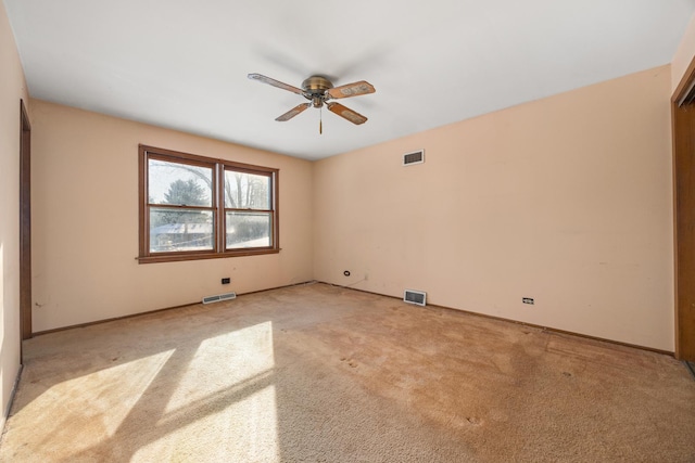 unfurnished room with light colored carpet and ceiling fan