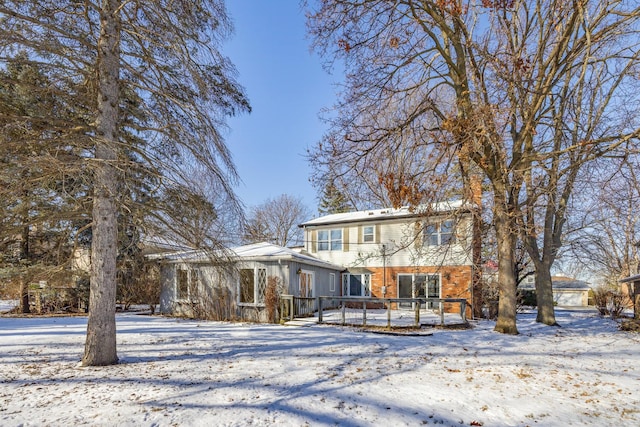 snow covered property featuring a wooden deck