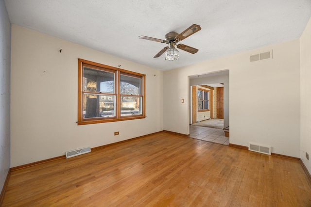 unfurnished room with ceiling fan and light wood-type flooring