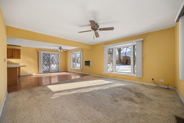 spare room with carpet flooring, a wall mounted AC, and ceiling fan