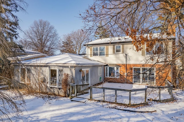 view of snow covered rear of property