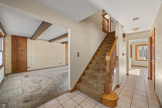 stairs with beam ceiling and carpet