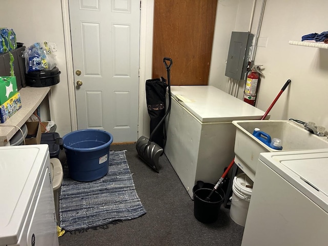 laundry room with independent washer and dryer, electric panel, and sink