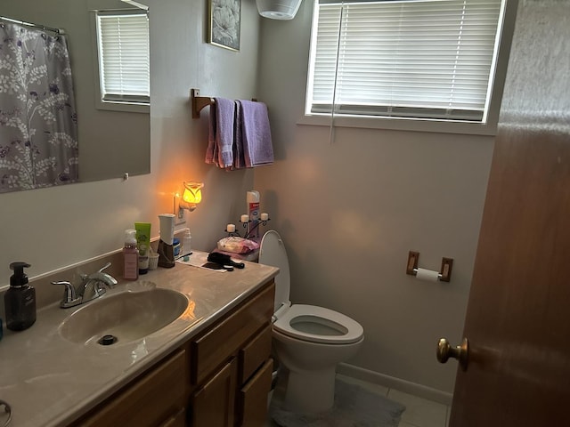 bathroom with vanity, tile patterned floors, and toilet