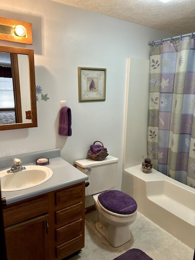 bathroom featuring tile patterned floors, toilet, a shower with curtain, a textured ceiling, and vanity