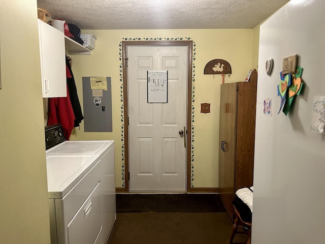 clothes washing area featuring washer and clothes dryer, electric panel, cabinets, and a textured ceiling