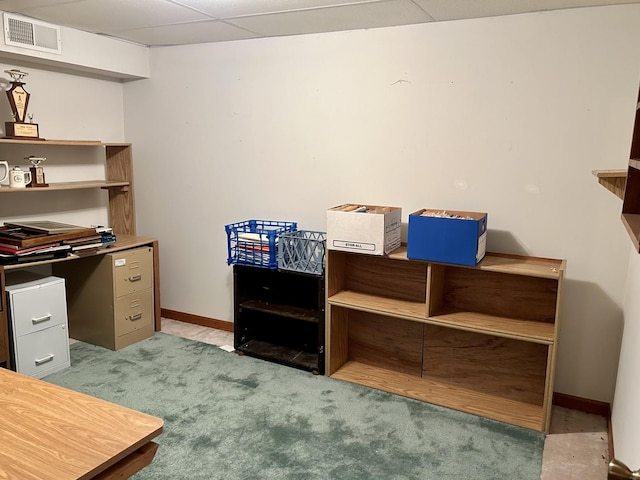 carpeted office with a drop ceiling