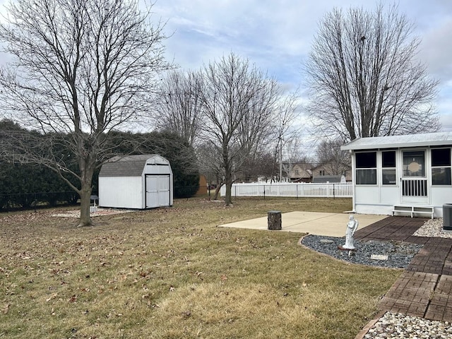 view of yard featuring a storage shed, central air condition unit, and a patio area