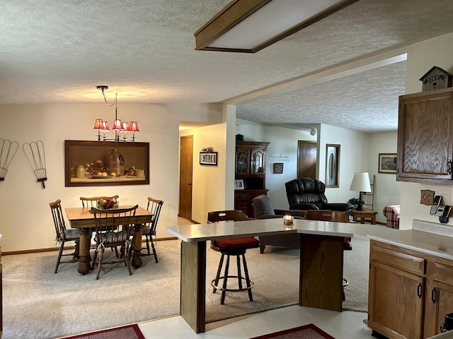 carpeted dining space with a textured ceiling