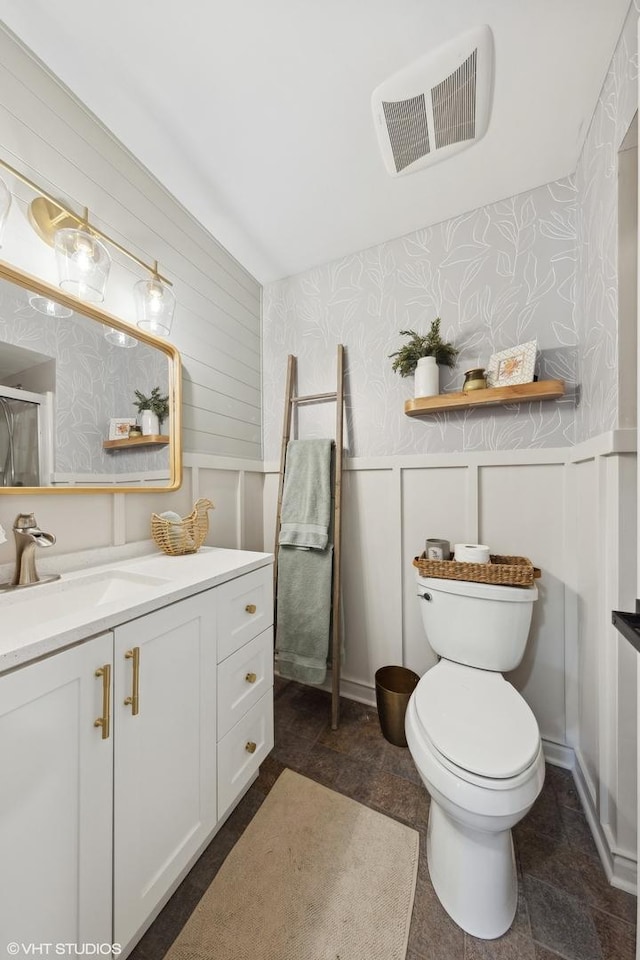 bathroom featuring vanity, toilet, and walk in shower