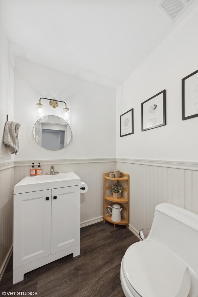 bathroom featuring vanity, hardwood / wood-style floors, and toilet