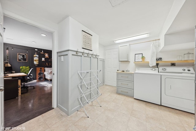 clothes washing area with separate washer and dryer and light tile patterned floors