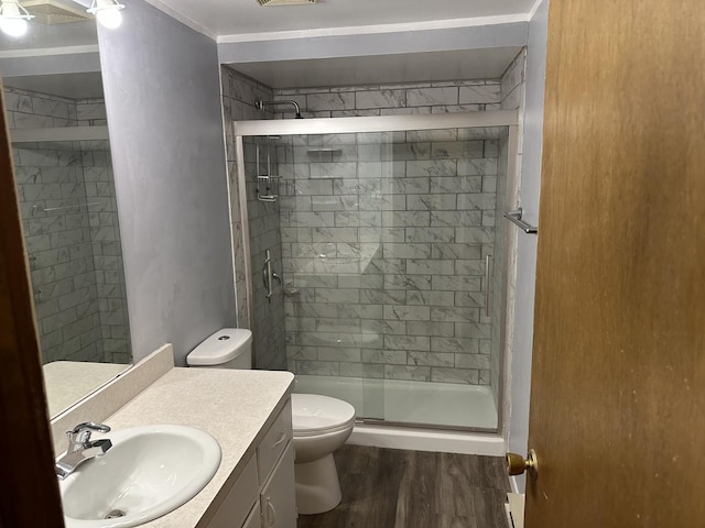 bathroom featuring vanity, toilet, an enclosed shower, and hardwood / wood-style floors