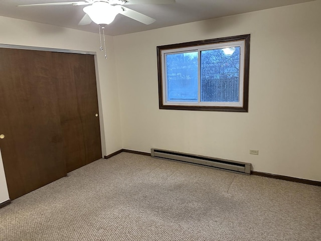 unfurnished bedroom with ceiling fan, a closet, light carpet, and a baseboard heating unit