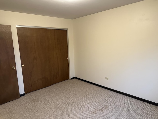 unfurnished bedroom featuring light carpet