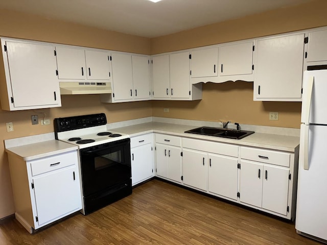 kitchen featuring range with electric stovetop, white cabinetry, and white fridge