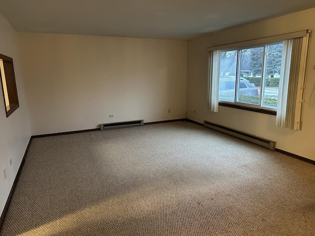 spare room featuring a baseboard radiator and carpet flooring