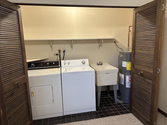 clothes washing area featuring separate washer and dryer, electric water heater, sink, and dark tile patterned flooring