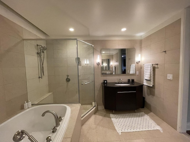 bathroom with vanity, tile patterned flooring, plus walk in shower, and tile walls