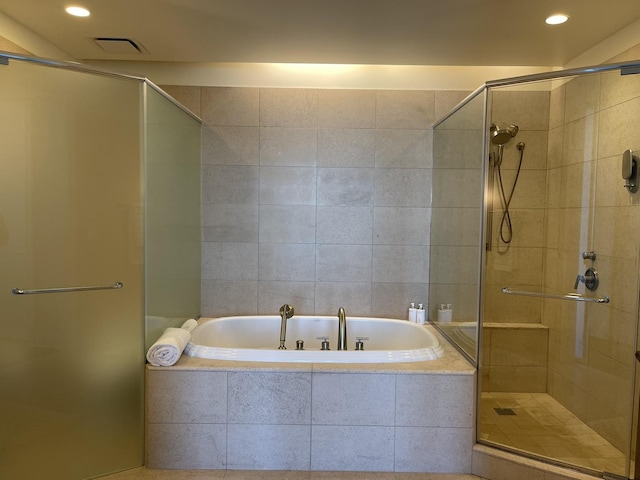 bathroom with separate shower and tub