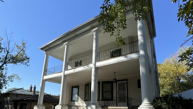 view of home's exterior featuring a balcony and covered porch