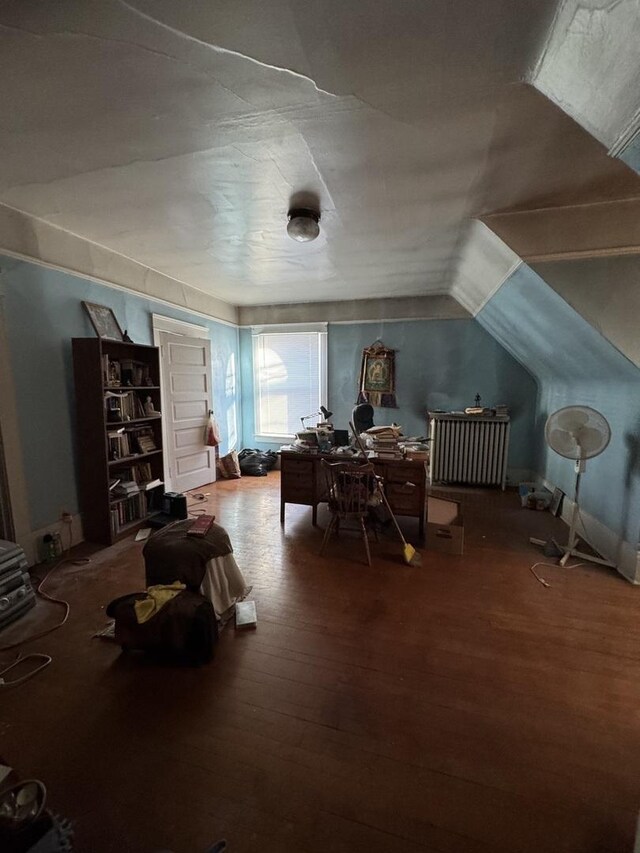 interior space with vaulted ceiling and wood finished floors