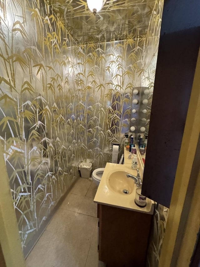 bathroom with vanity, tile patterned flooring, and toilet