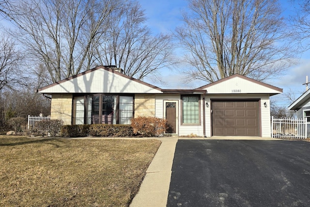 single story home with a garage and a front lawn