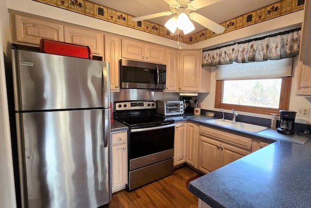 kitchen featuring sink, light brown cabinets, appliances with stainless steel finishes, dark hardwood / wood-style flooring, and ceiling fan