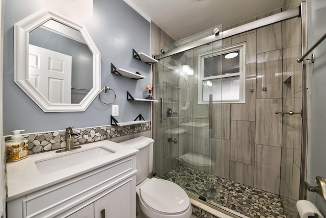 bathroom with vanity, toilet, and an enclosed shower