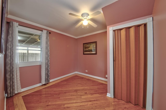 empty room featuring crown molding, ceiling fan, and light hardwood / wood-style flooring