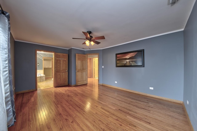 unfurnished bedroom with crown molding, hardwood / wood-style flooring, and ensuite bathroom