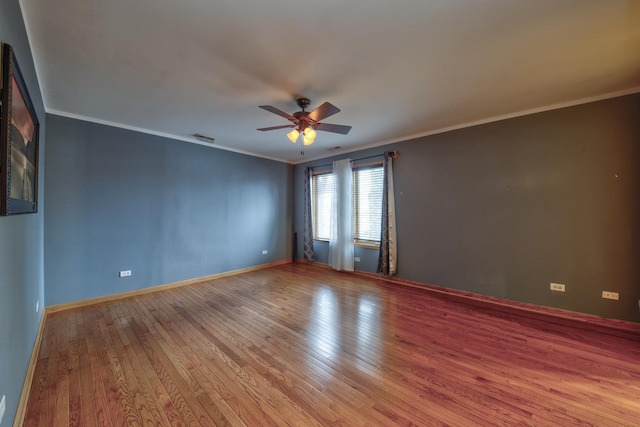 spare room featuring ceiling fan, ornamental molding, and wood-type flooring