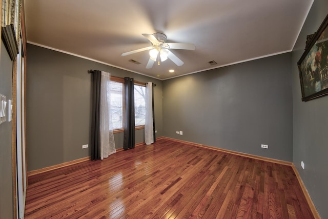 empty room with hardwood / wood-style flooring, ceiling fan, and crown molding