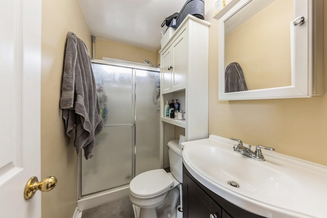 bathroom with toilet, a stall shower, and vanity