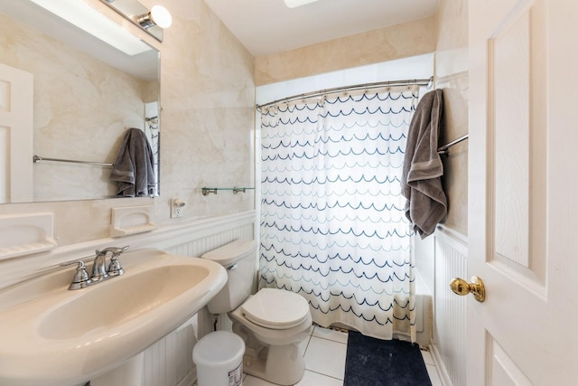 bathroom with tile patterned flooring, a sink, and toilet