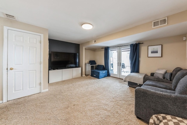 living room featuring carpet, visible vents, and french doors