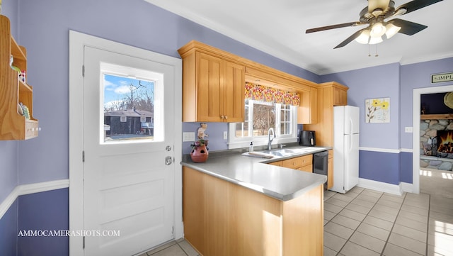 kitchen featuring white refrigerator, sink, light brown cabinetry, and kitchen peninsula