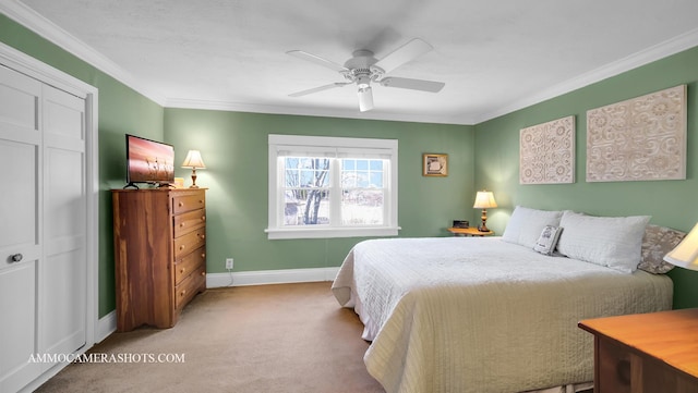 carpeted bedroom featuring crown molding, ceiling fan, and a closet