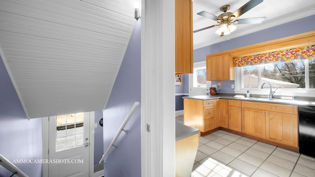 kitchen with sink, light tile patterned floors, black dishwasher, and ceiling fan