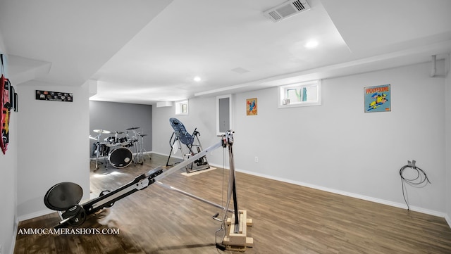 exercise room with hardwood / wood-style floors