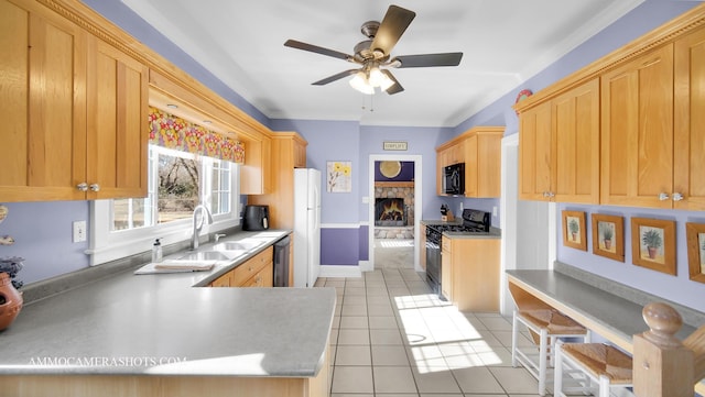 kitchen featuring a stone fireplace, black appliances, sink, light tile patterned floors, and kitchen peninsula