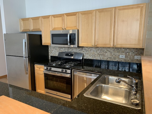 kitchen with tasteful backsplash, sink, light brown cabinetry, and appliances with stainless steel finishes