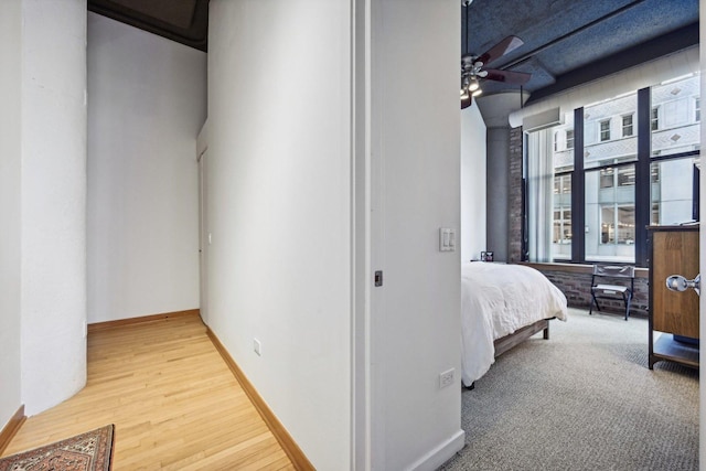 hallway with hardwood / wood-style floors