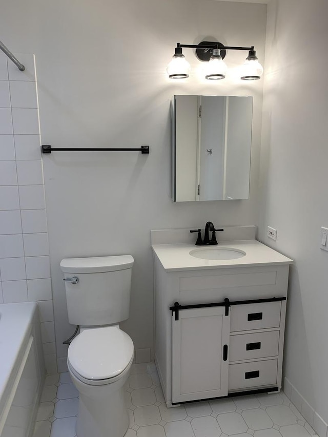 bathroom featuring vanity and toilet