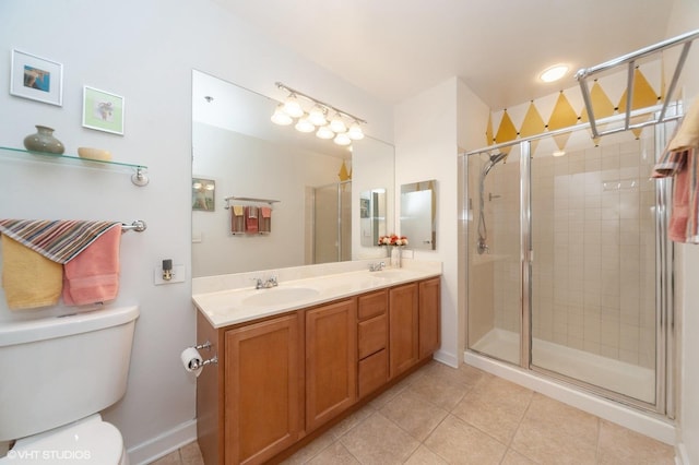 bathroom featuring tile patterned floors, toilet, vanity, and walk in shower