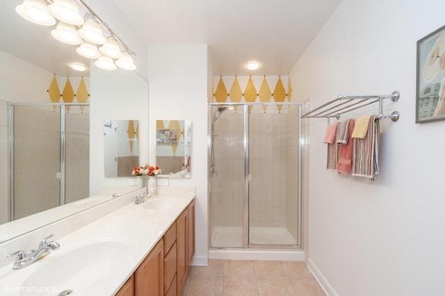 bathroom featuring vanity, a shower with door, and tile patterned floors