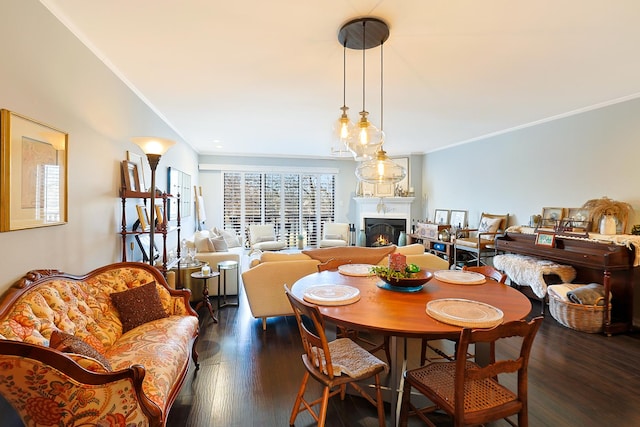 dining room with dark wood-type flooring and crown molding