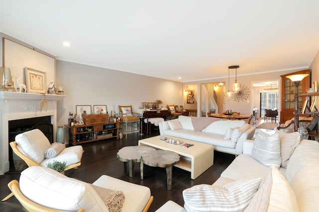 living room with dark wood-type flooring and crown molding