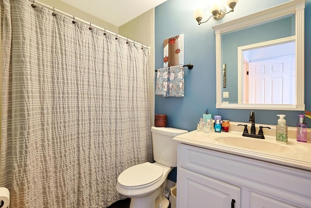 bathroom with walk in shower, vanity, and toilet